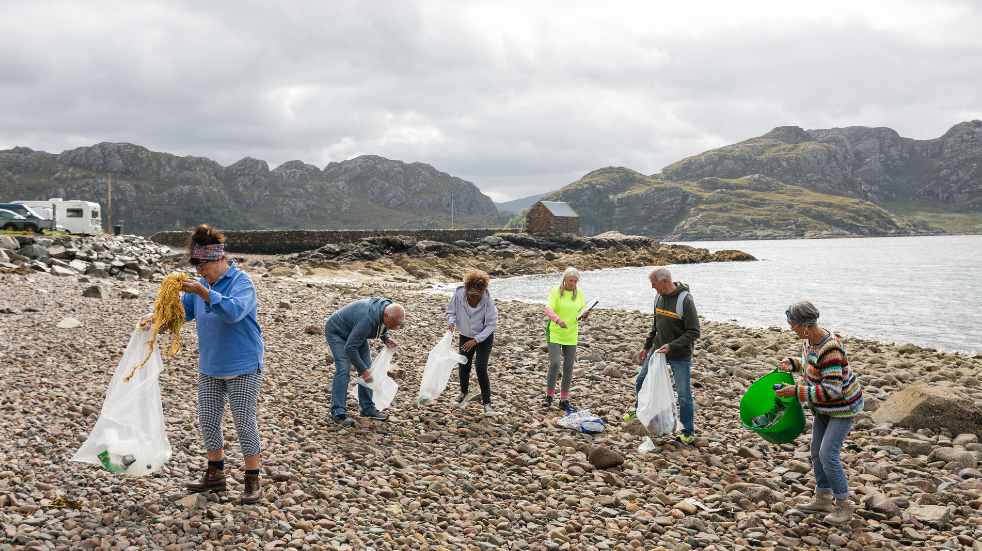 Group of people cleaning beach